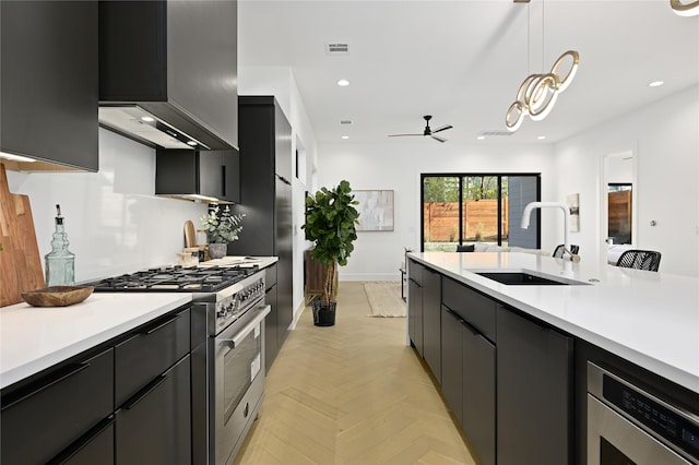 kitchen featuring ceiling fan, stainless steel range, sink, hanging light fixtures, and light parquet floors