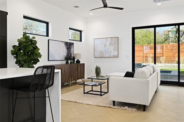 living room with light parquet flooring and ceiling fan