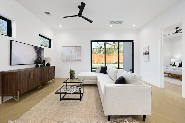 living room featuring ceiling fan and light parquet flooring