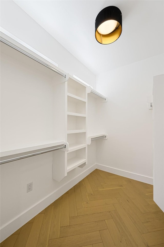 walk in closet featuring parquet floors