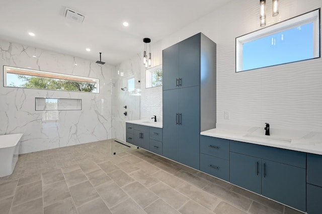 bathroom with vanity and a tile shower