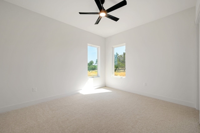 spare room with carpet floors and ceiling fan