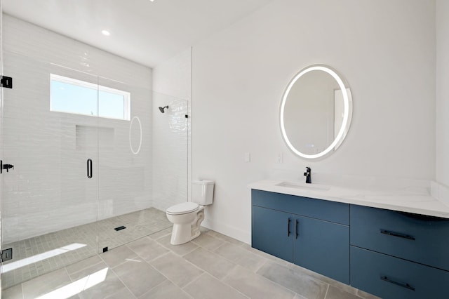 bathroom featuring tile patterned flooring, a shower with door, vanity, and toilet