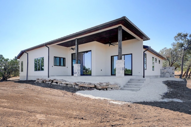 back of property featuring ceiling fan