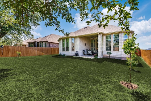 back of house featuring ceiling fan, a yard, and a patio