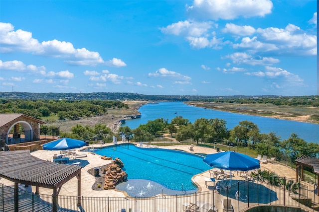 view of swimming pool with a water view and a patio area