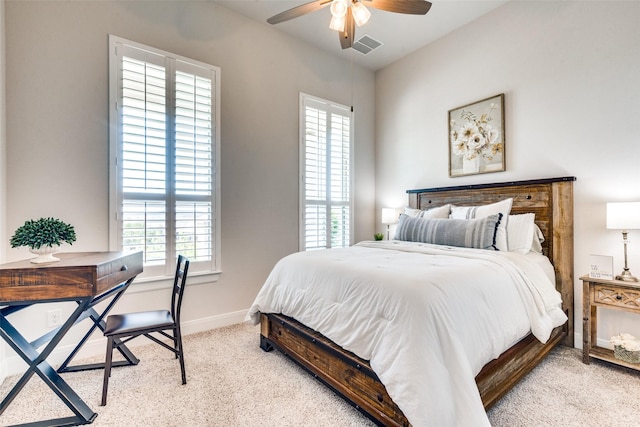 carpeted bedroom with multiple windows and ceiling fan