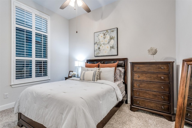 bedroom with ceiling fan and light carpet