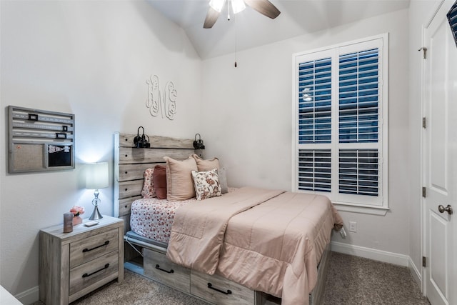 carpeted bedroom with ceiling fan and vaulted ceiling