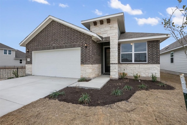 view of front facade featuring brick siding, fence, a garage, stone siding, and driveway