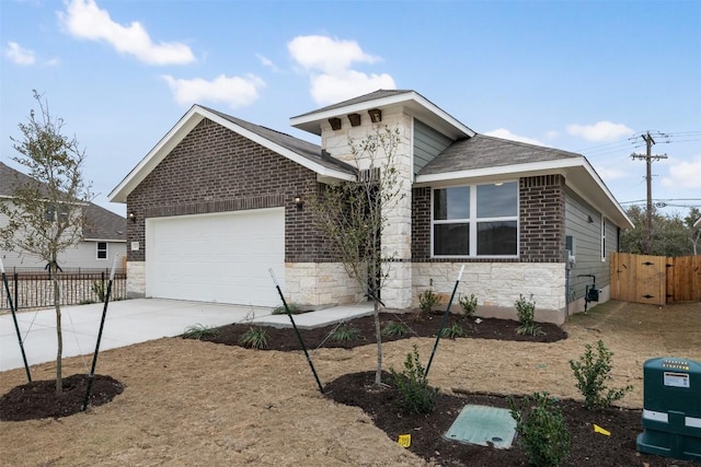 view of front of house featuring an attached garage, brick siding, fence, concrete driveway, and stone siding