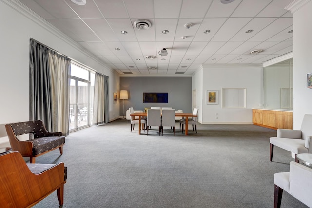 interior space with carpet flooring, a paneled ceiling, and ornamental molding