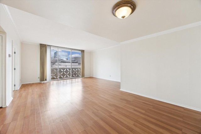 unfurnished living room with ornamental molding and light wood-type flooring