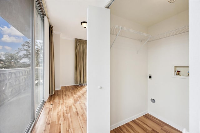 washroom featuring electric dryer hookup, hookup for a washing machine, and hardwood / wood-style flooring