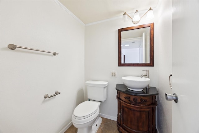 bathroom featuring tile patterned floors, toilet, vanity, and ornamental molding