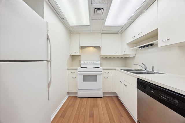 kitchen featuring light hardwood / wood-style floors, white cabinetry, white appliances, and sink