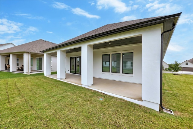 back of property with a lawn and a patio area