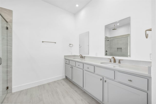 bathroom with vanity, wood-type flooring, and an enclosed shower