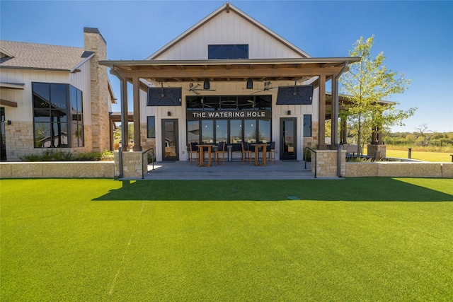 back of property with a patio and a lawn