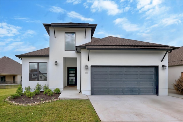 view of front of house featuring a garage and a front yard