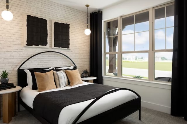 carpeted bedroom featuring brick wall