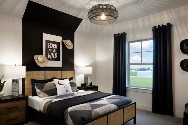 carpeted bedroom with a chandelier