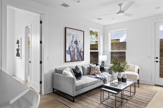 living room featuring light wood-type flooring and ceiling fan