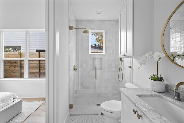 bathroom with toilet, tile patterned floors, walk in shower, and vanity