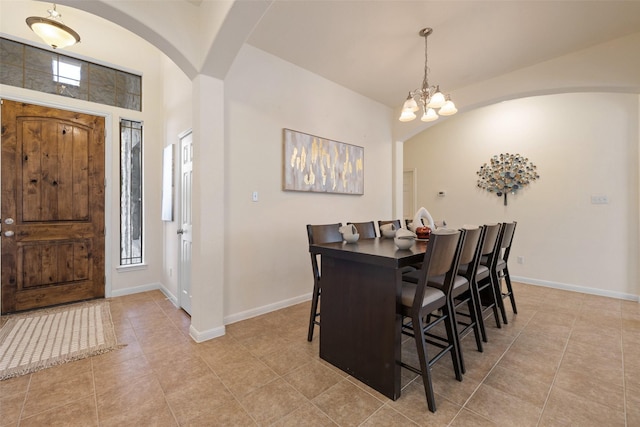 tiled dining space with a chandelier