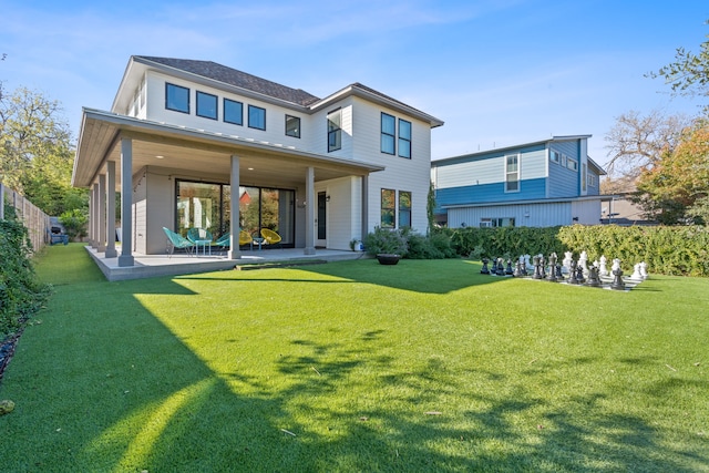 back of property featuring a patio and a lawn