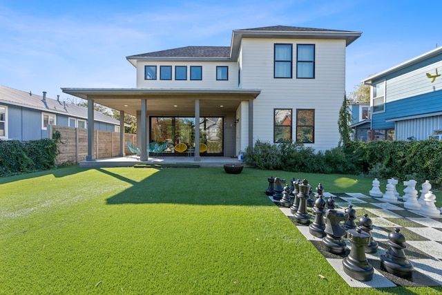 back of property with a lawn and a patio