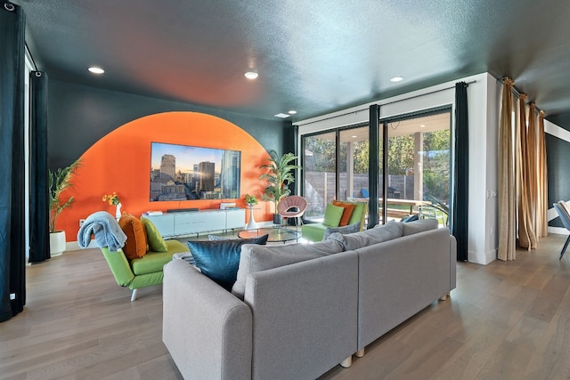 1604 Miriam Ave, Austin, TX 78702 - living area featuring wood finished floors, recessed lighting, a textured ceiling, and baseboards