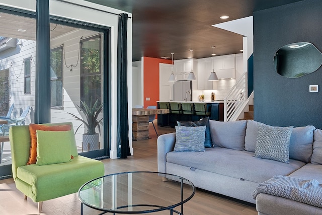 1604 Miriam Ave, Austin, TX 78702 - living room featuring light wood-style floors, stairs, and recessed lighting