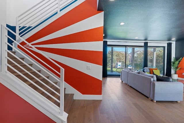 1604 Miriam Ave, Austin, TX 78702 - living area featuring recessed lighting, wood finished floors, floor to ceiling windows, stairs, and a textured ceiling