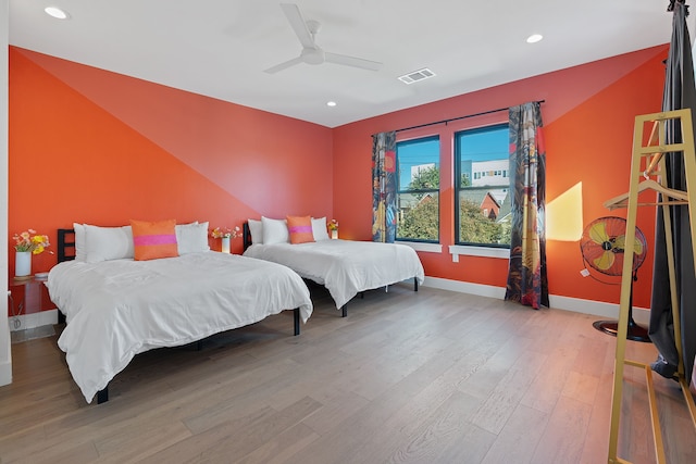 bedroom with hardwood / wood-style floors and ceiling fan