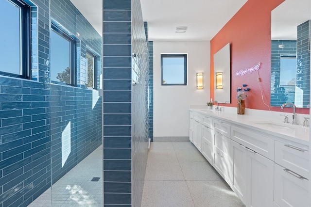 1604 Miriam Ave, Austin, TX 78702 - bathroom with double vanity, walk in shower, and baseboards