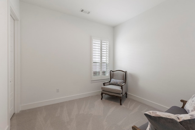 sitting room featuring light colored carpet