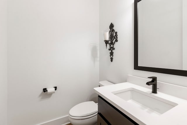 bathroom featuring toilet and vanity