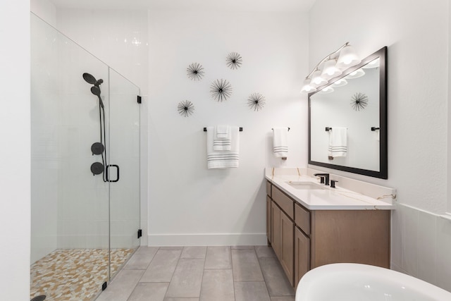 bathroom with a shower with shower door and vanity