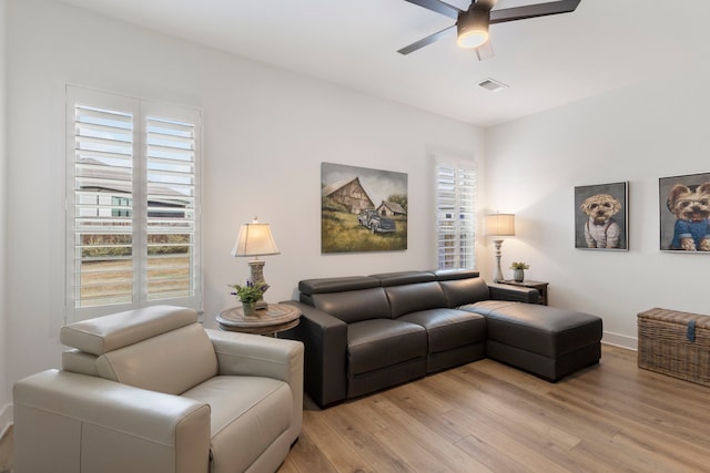 living room with ceiling fan and light wood-type flooring