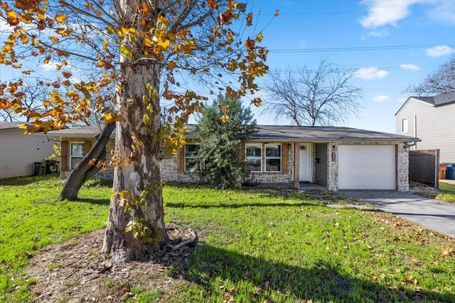 ranch-style home featuring a front lawn and a garage