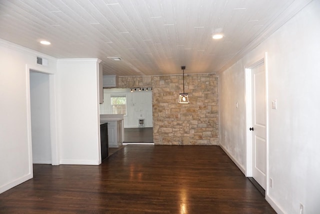 spare room featuring ornamental molding and dark wood-type flooring