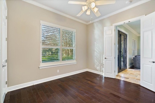 empty room with hardwood / wood-style floors, ornamental molding, and ceiling fan