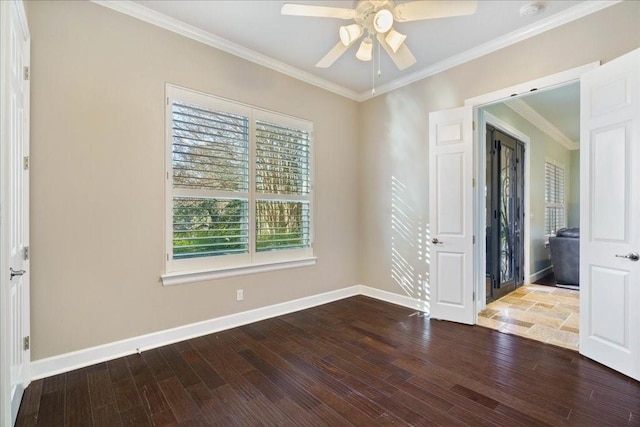 empty room featuring ceiling fan, baseboards, ornamental molding, and wood finished floors