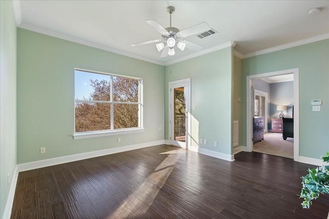 spare room with visible vents, a ceiling fan, hardwood / wood-style flooring, and ornamental molding