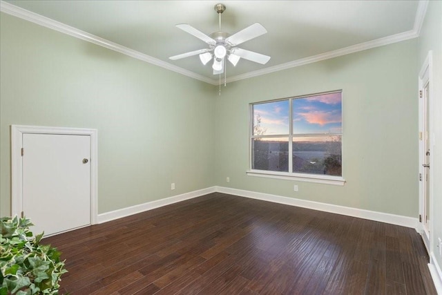 empty room featuring crown molding, ceiling fan, and dark wood finished floors