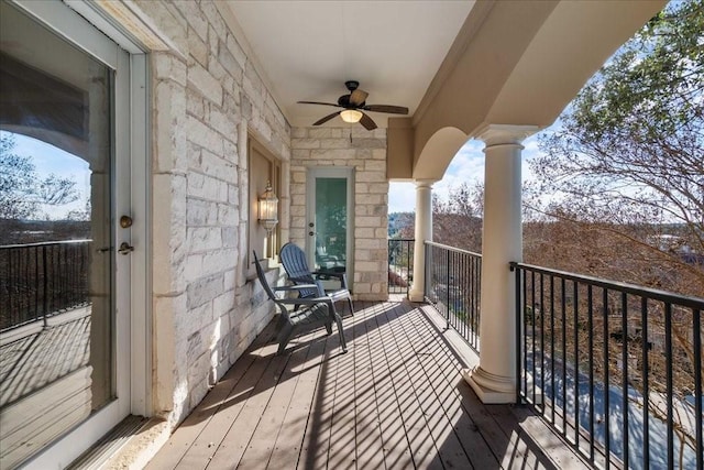 wooden deck with a ceiling fan