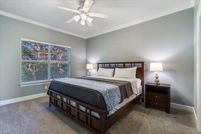 carpeted bedroom with ceiling fan and crown molding