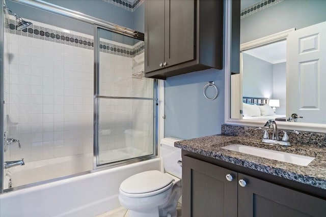 bathroom featuring toilet, crown molding, vanity, and combined bath / shower with glass door