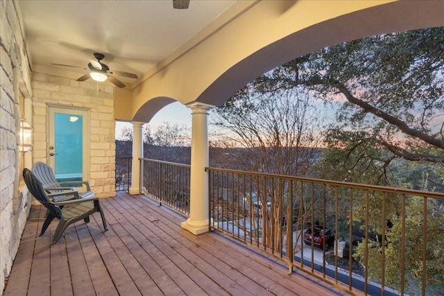deck at dusk with a ceiling fan